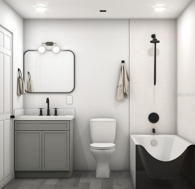 bathroom with vanity, toilet, and a bathtub