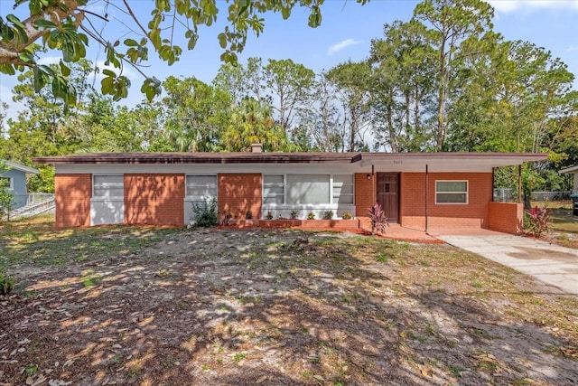 ranch-style home featuring a carport