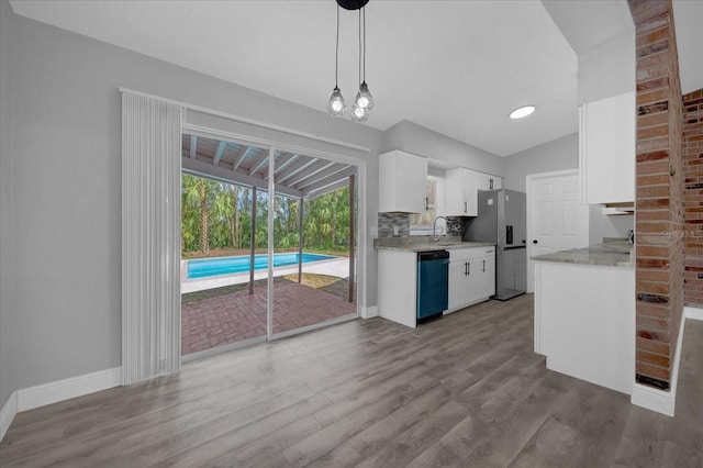 kitchen featuring hanging light fixtures, stainless steel fridge with ice dispenser, light wood-type flooring, white cabinets, and black dishwasher