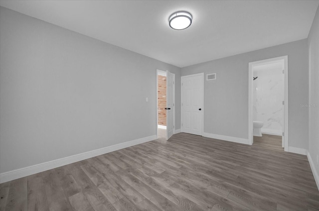 empty room with hardwood / wood-style floors