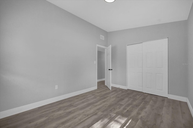 unfurnished bedroom with a closet and light hardwood / wood-style floors