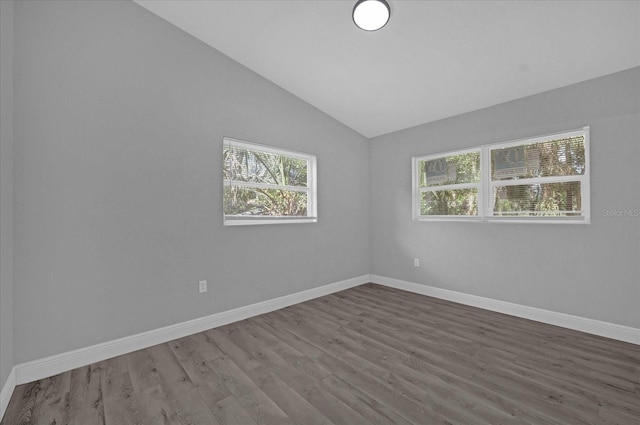 empty room featuring lofted ceiling and hardwood / wood-style floors