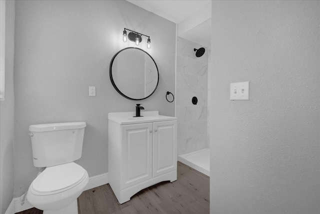 bathroom featuring walk in shower, hardwood / wood-style floors, vanity, and toilet