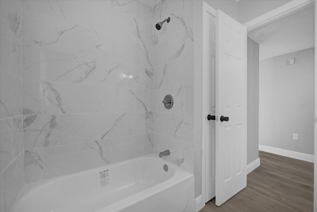 bathroom featuring tiled shower / bath and hardwood / wood-style floors