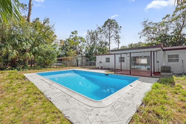 view of swimming pool featuring cooling unit and a patio area