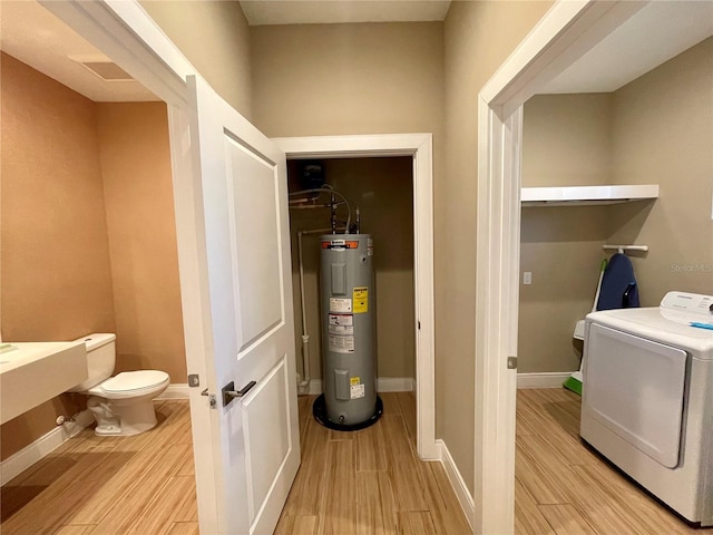 laundry room featuring light hardwood / wood-style floors and water heater