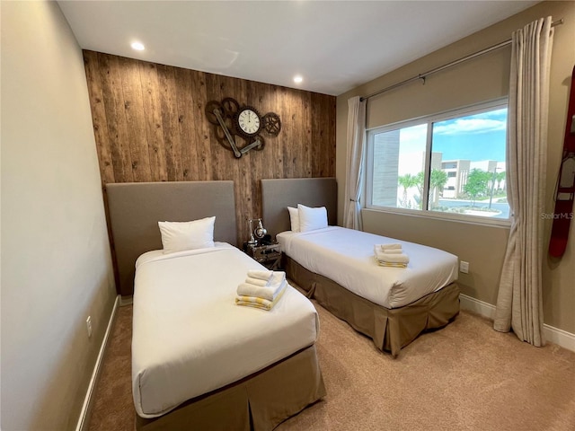 bedroom featuring carpet and wooden walls