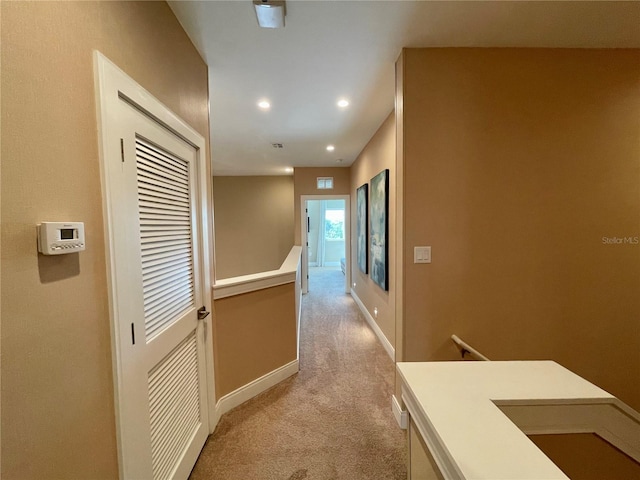 corridor with light colored carpet