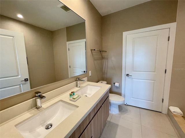 bathroom featuring vanity, toilet, and tile patterned flooring