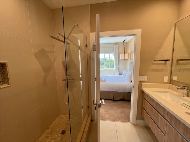 bathroom featuring vanity and tiled shower