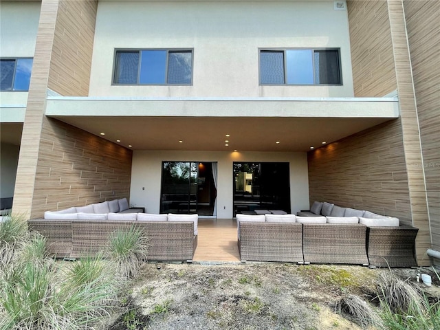 rear view of property with an outdoor hangout area