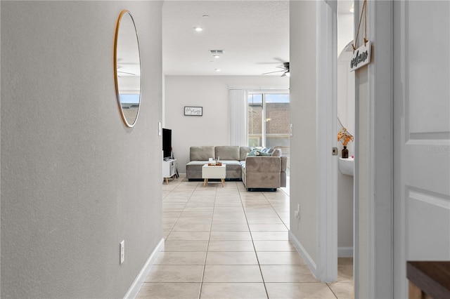 hall with light tile patterned flooring