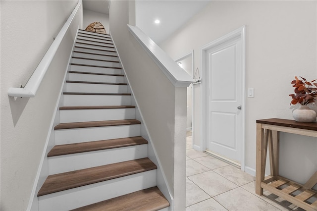 stairway featuring tile patterned flooring