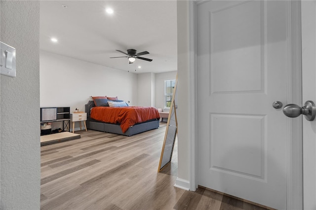 bedroom with ceiling fan and light wood-type flooring