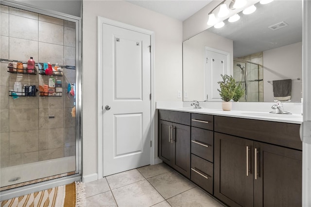 bathroom featuring vanity, tile patterned floors, and a shower with shower door