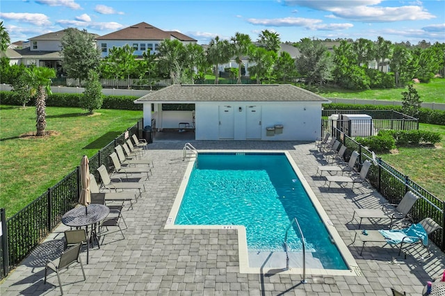 view of swimming pool featuring a patio and a lawn