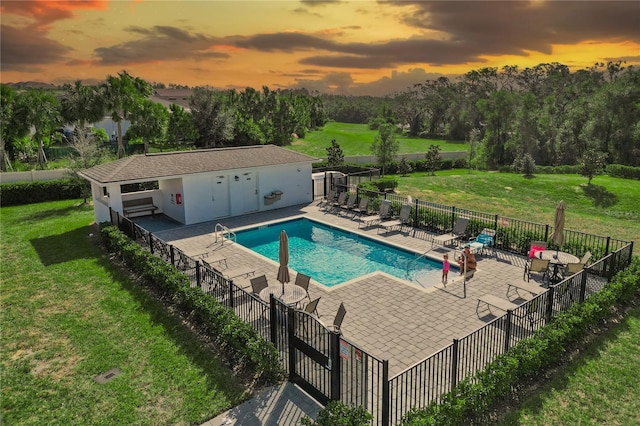 pool at dusk with a yard and a patio