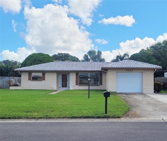 single story home with a garage and a front lawn