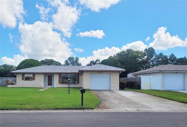 single story home featuring a front lawn and a garage