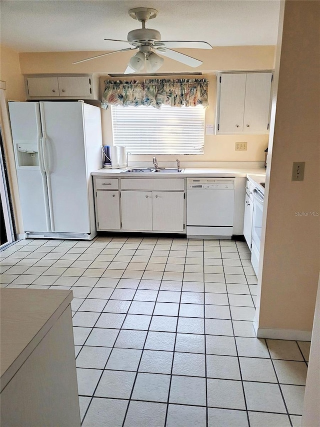 kitchen featuring light tile patterned flooring, white appliances, sink, and white cabinets