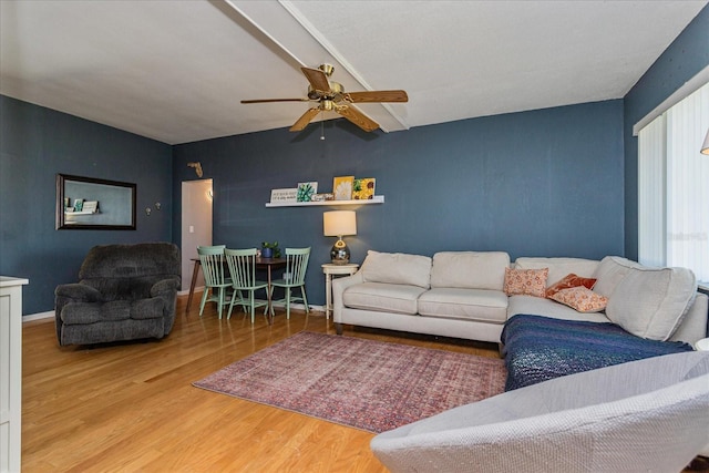 living room featuring hardwood / wood-style flooring and ceiling fan