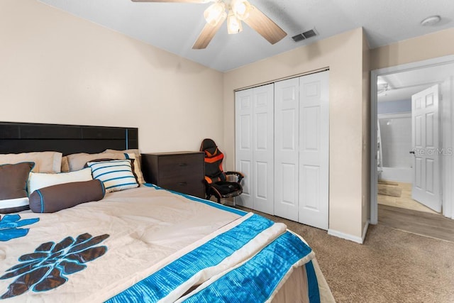 carpeted bedroom featuring a closet and ceiling fan