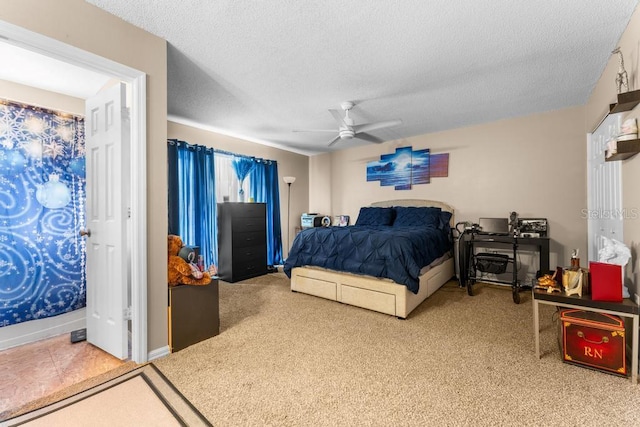 carpeted bedroom featuring a textured ceiling and ceiling fan