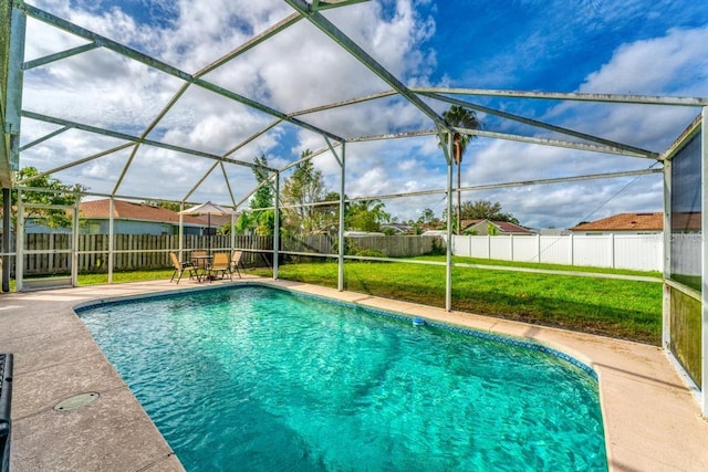 view of swimming pool featuring glass enclosure, a lawn, and a patio