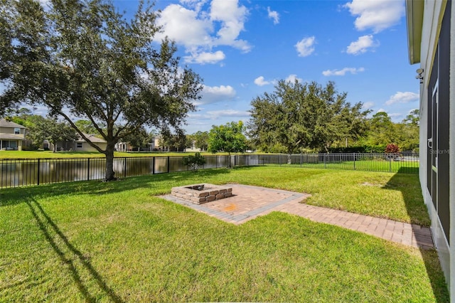 view of yard featuring a water view and an outdoor fire pit