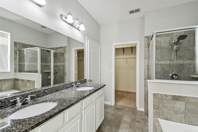 bathroom featuring walk in shower and vanity