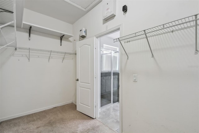 spacious closet with light colored carpet