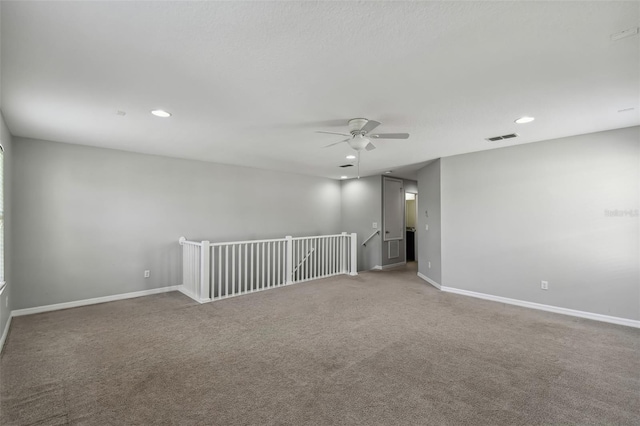 carpeted empty room featuring ceiling fan