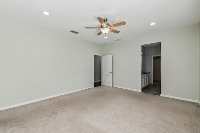 spare room with carpet and ceiling fan