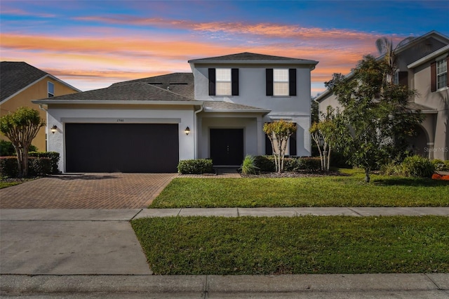 view of front of house with a lawn and a garage