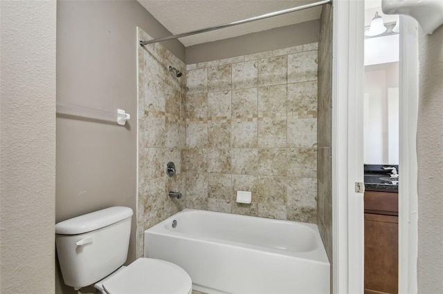 bathroom with tiled shower / bath, a textured ceiling, and toilet