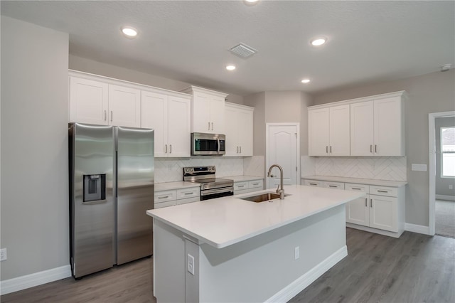 kitchen featuring sink, white cabinetry, stainless steel appliances, and light wood-type flooring