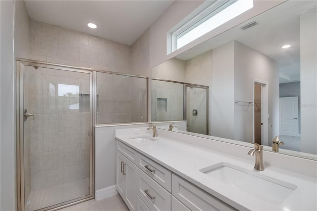 bathroom with vanity and a shower with shower door