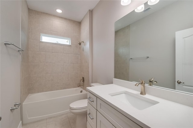 full bathroom featuring toilet, tiled shower / bath, vanity, and tile patterned floors