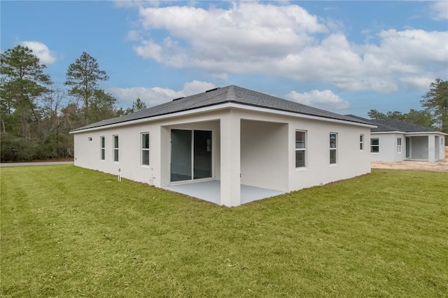 back of house featuring a patio area and a lawn