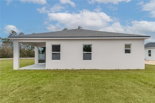 rear view of property with a patio area and a lawn