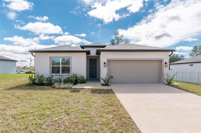 view of front of property with driveway, an attached garage, fence, a front lawn, and stucco siding