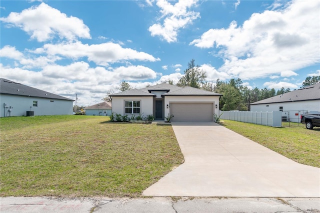 view of front of property featuring a front lawn, driveway, an attached garage, and fence