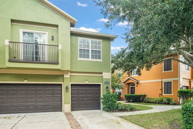 view of property with a garage and a balcony