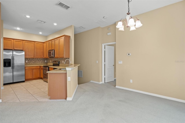 kitchen with tasteful backsplash, appliances with stainless steel finishes, kitchen peninsula, a chandelier, and light colored carpet