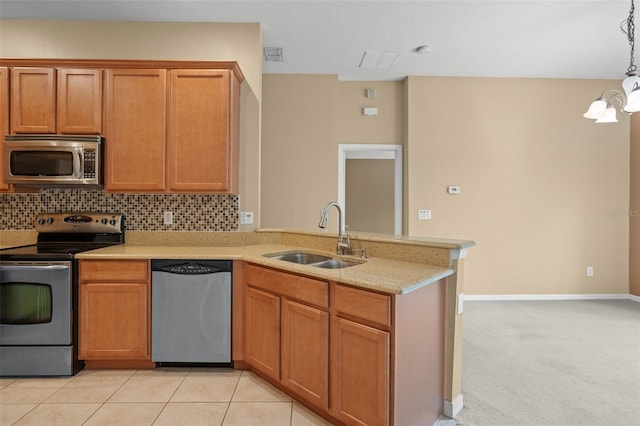 kitchen with light carpet, tasteful backsplash, appliances with stainless steel finishes, pendant lighting, and sink