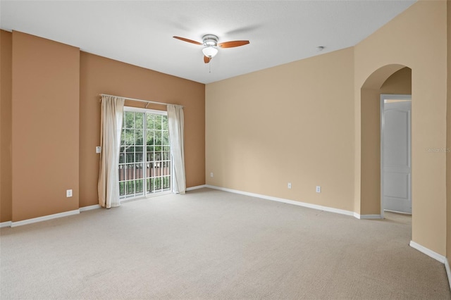 unfurnished room with light colored carpet and ceiling fan