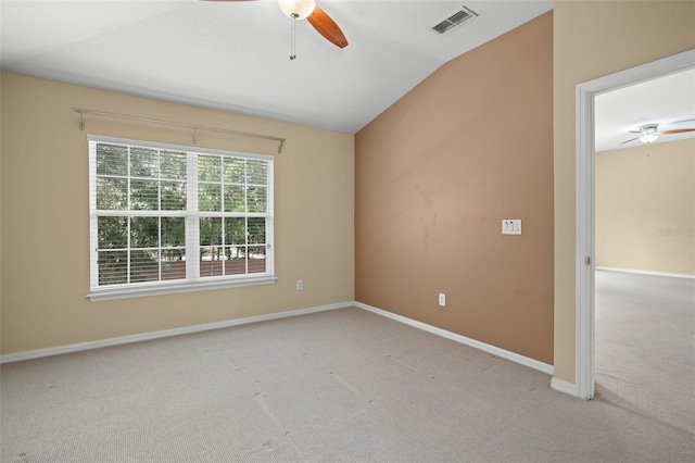 unfurnished room featuring light carpet, lofted ceiling, and ceiling fan