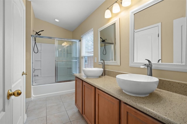 bathroom featuring vanity, lofted ceiling, tile patterned floors, and shower / bath combination with glass door