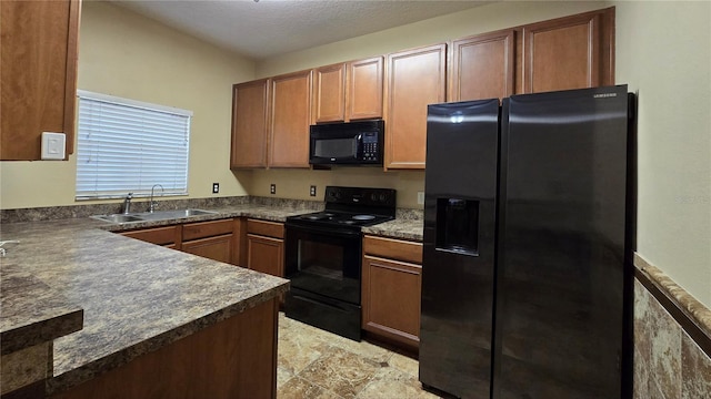 kitchen with sink, black appliances, and a textured ceiling