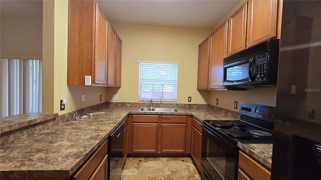 kitchen with kitchen peninsula, black appliances, and sink